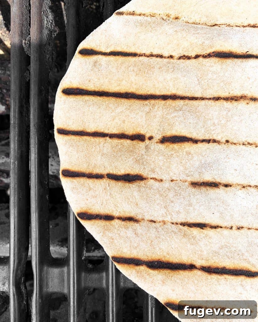 Crispy Grilled Pizza Delights 6 Pizza crust cooking directly on the grill grates, showing perfect char marks and puffing.