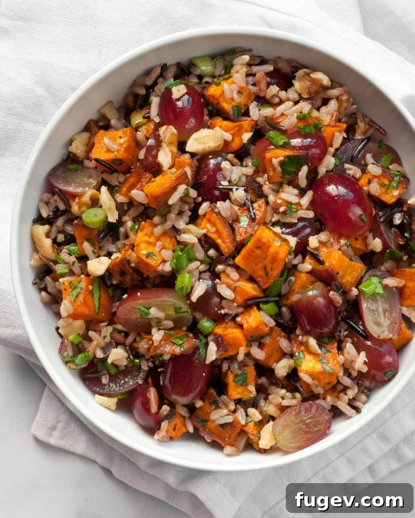 Sweet Potato Wild Rice and Grape Medley 4 A large serving bowl filled with Sweet Potato Grape Wild Rice Salad, ready to be enjoyed.