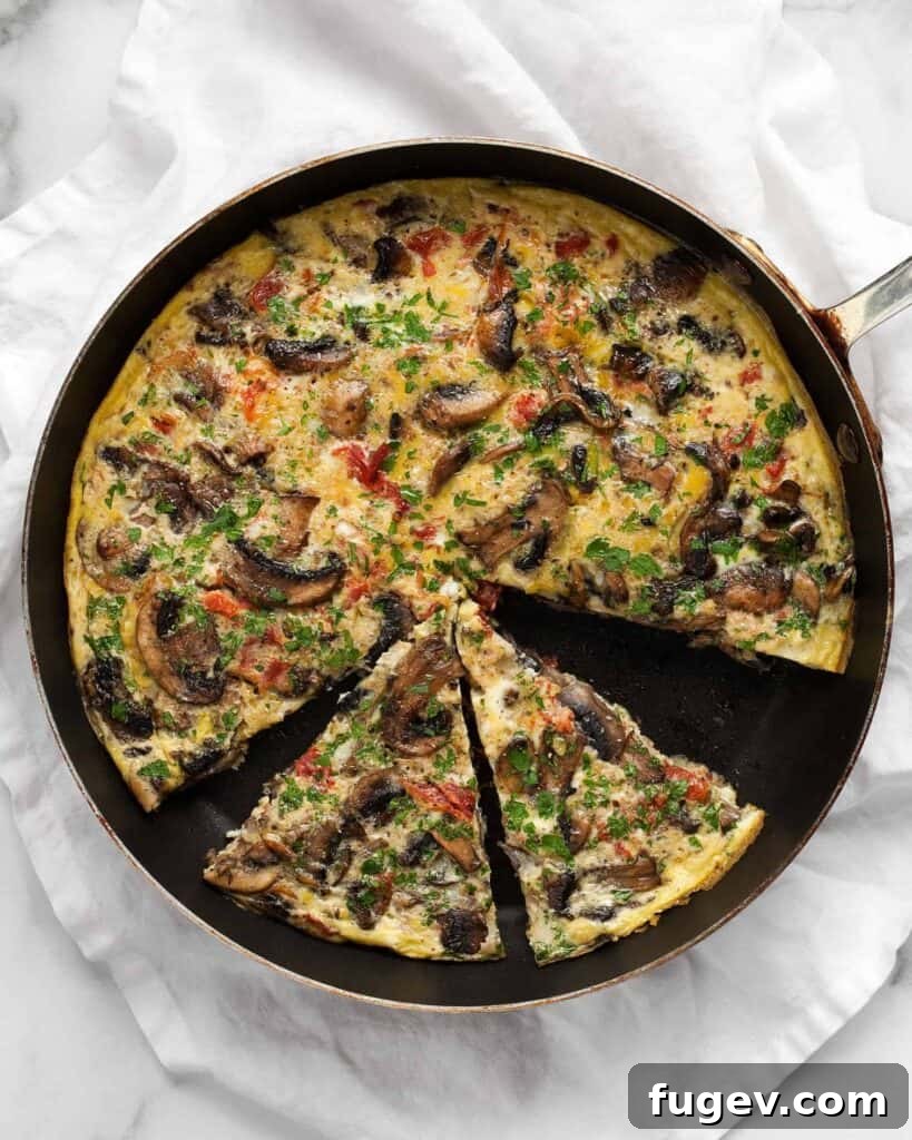 Savory Mushroom and Tomato Frittata 2 Sliced mushroom tomato frittata in a skillet