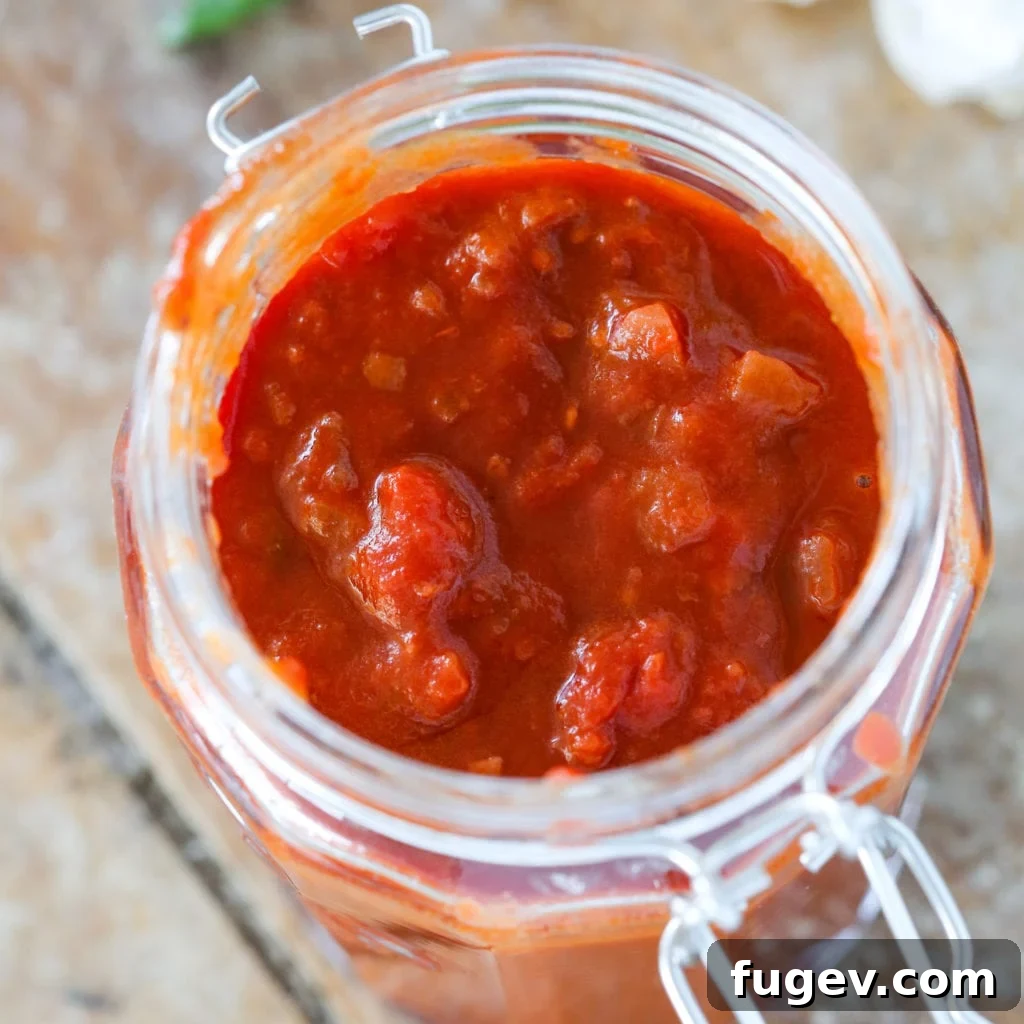 Robust Red Wine Pasta Sauce 3 Red wine pasta sauce inside of a mason jar on a wood slate background.