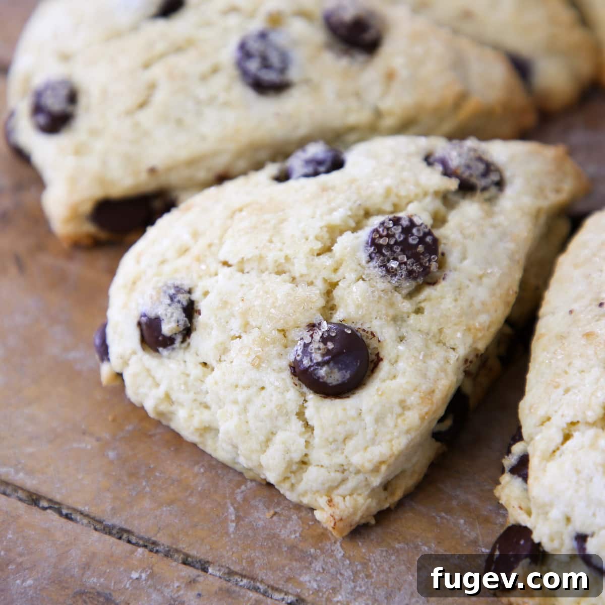 Heavenly Chocolate Chip Scones 4 Collection of baked chocolate chip scones arranged neatly on a wooden board, ready to serve.