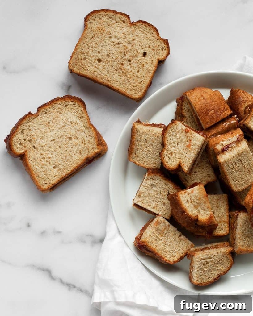 Almond Butter & Jelly French Toast Bake 6 Making almond butter and jelly sandwiches and cutting them into quarters