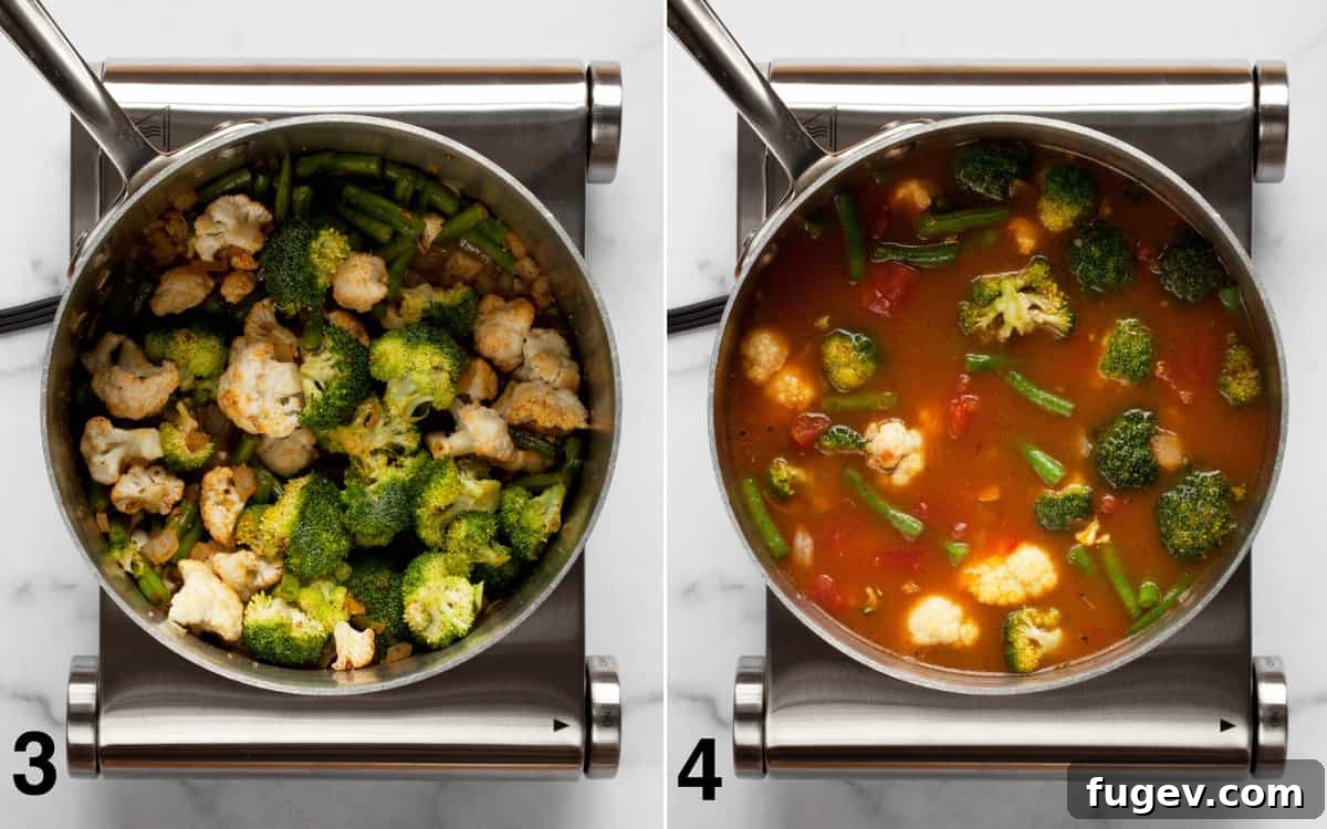 Comforting Harvest Vegetable Soup 5 The cooking process for hearty vegetable soup, showing the broccoli, cauliflower, and green beans being stirred into the sautéed onions in a saucepan, followed by the addition of diced tomatoes, vegetable broth, and water.