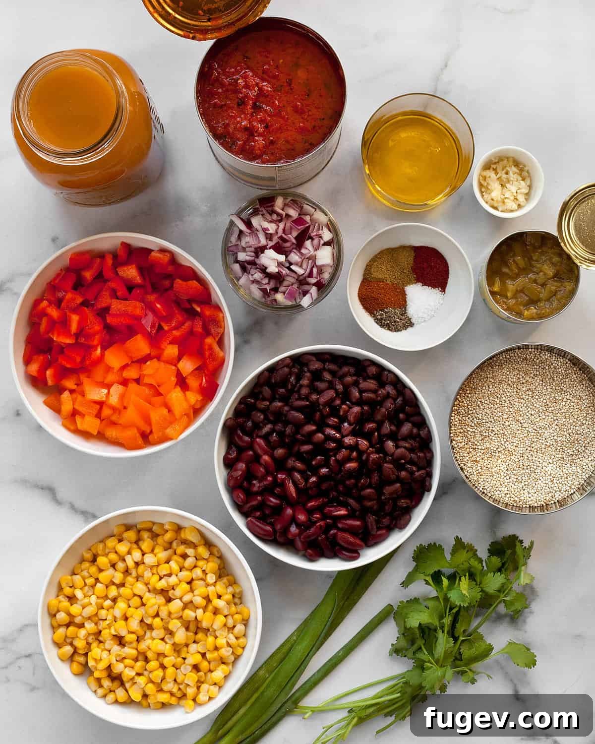 Savory Quinoa Chili with Rich Beans and Golden Corn 3 A vibrant selection of ingredients for quinoa chili including fresh peppers, corn, a variety of beans, spices, garlic, green chilies, and olive oil.