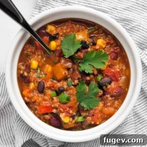 A bowl of delicious quinoa chili, garnished and ready to eat.