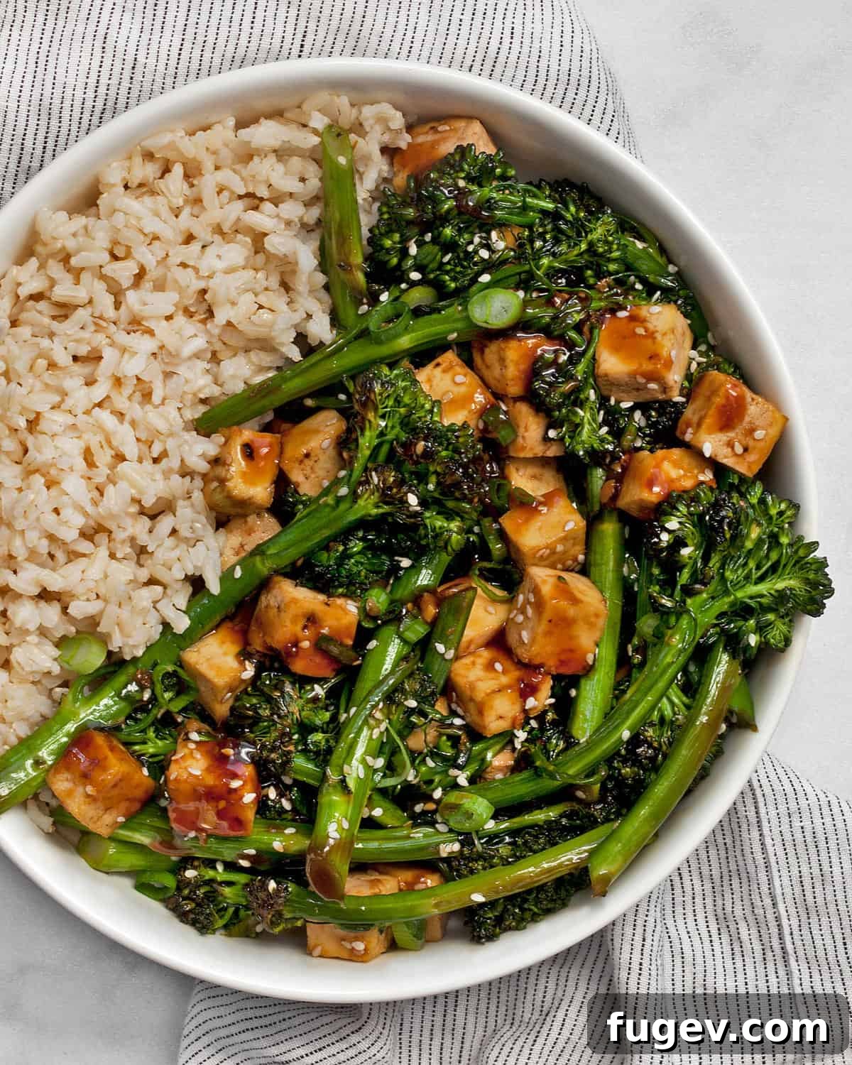 Glazed Teriyaki Tofu & Broccolini Sheet Pan Meal 2 Teriyaki tofu with broccolini and brown rice in a bowl.