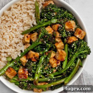 Teriyaki tofu with broccolini and brown rice in a bowl.