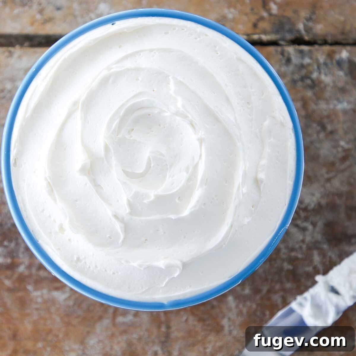 Dreamy Swiss Meringue Buttercream 4 Lush blue Swiss Meringue Buttercream filling a decorative bowl.