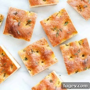 Rosemary Focaccia cut into squares on a wire rack.