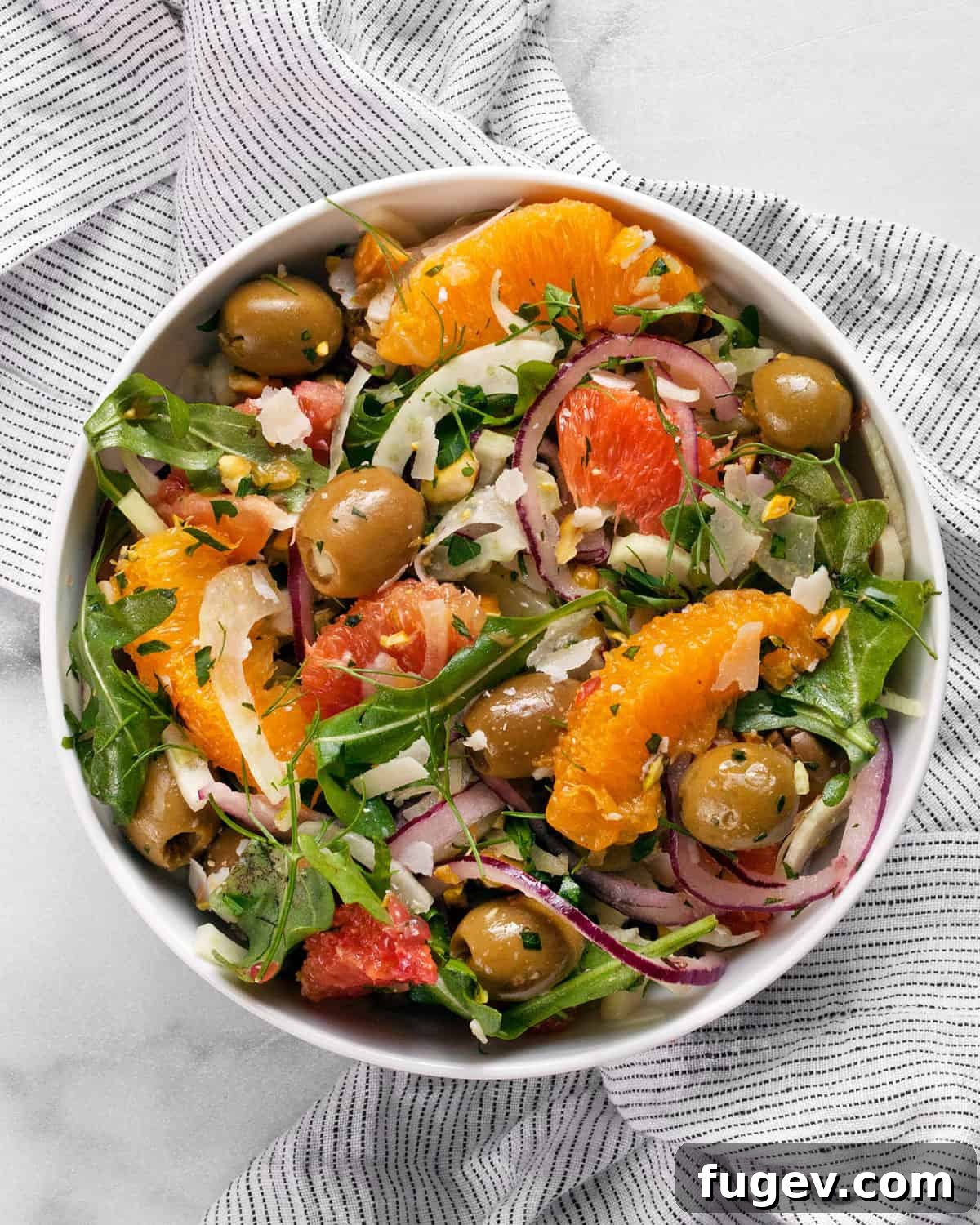 Refreshing Fennel Orange Salad 2 Bright and colorful orange salad with thinly sliced fennel and fresh arugula in a small serving bowl.