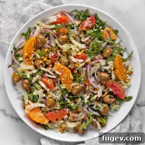 Orange salad with fennel and olives on a plate.