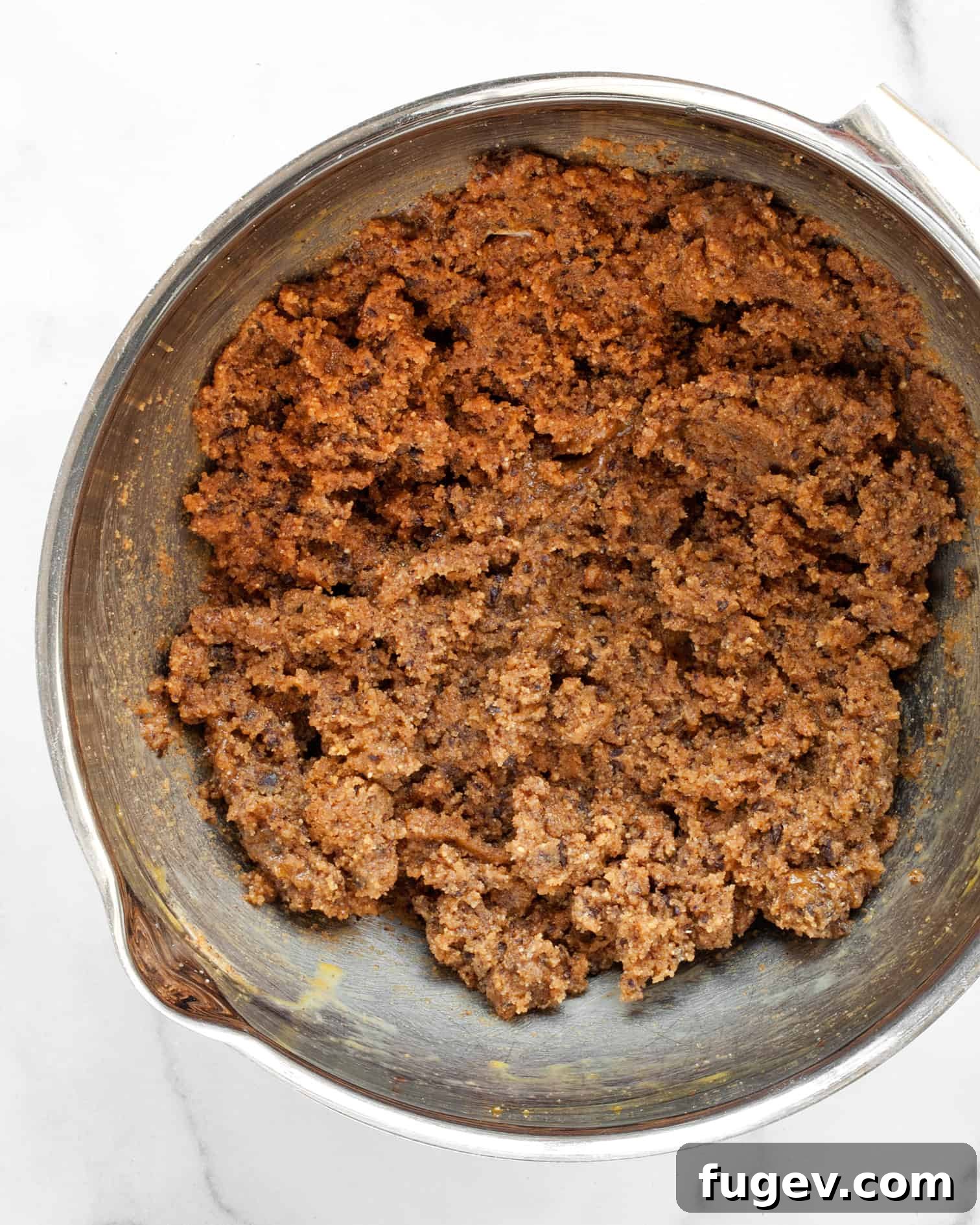 Decadent Peanut Butter Chocolate Chews 7 A bowl filled with the raw peanut butter cookie dough, showing its rich, creamy texture and ready for portioning.