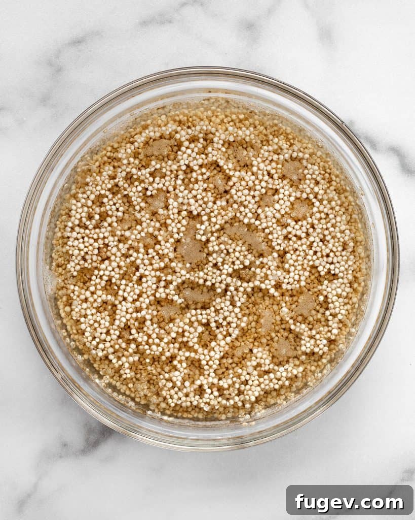 Nutrient-Packed Quinoa Crust 5 Uncooked quinoa soaking in a bowl of water, an essential first step.