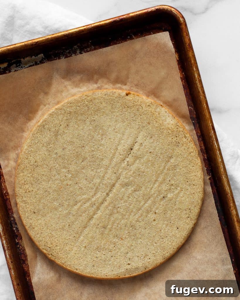 Nutrient-Packed Quinoa Crust 7 Golden-brown, baked quinoa pizza crust resting on a sheet pan.