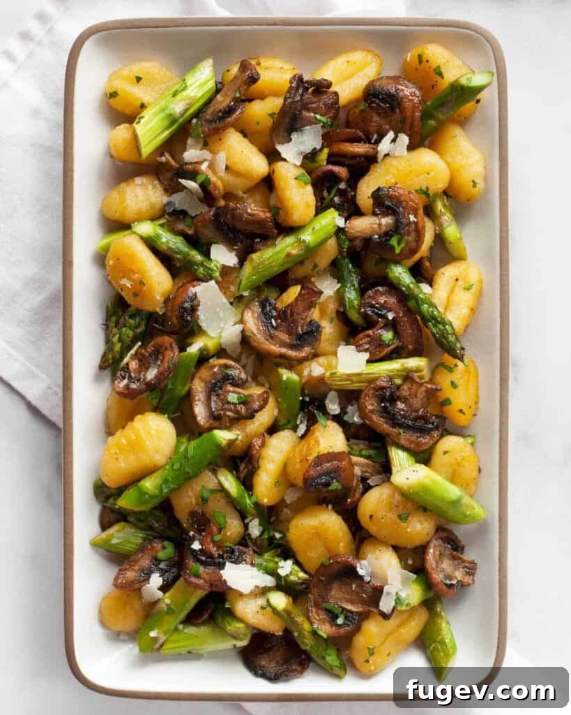 Garden Gnocchi Sheet Pan Feast 2 Delicious Sheet Pan Mushroom Asparagus Gnocchi served in a bowl, showing crispy gnocchi, tender asparagus, and browned mushrooms with a rich garlic-lemon glaze.