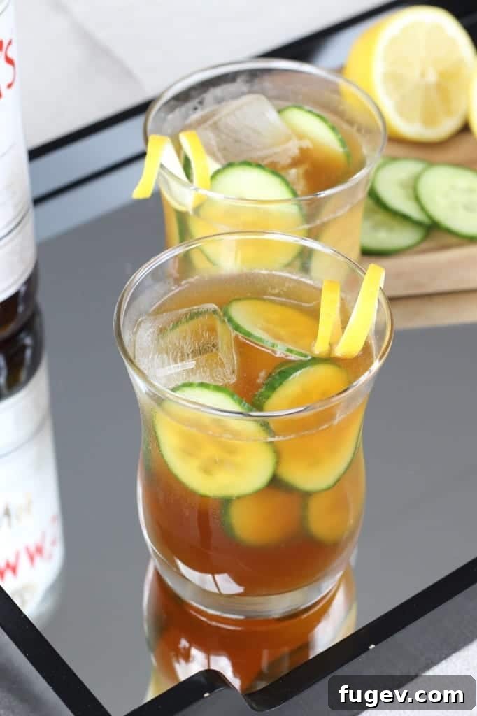 Garden Fresh Pimm's Cooler 3 Close-up of a Pimm's Cup cocktail garnished with cucumber and lemon