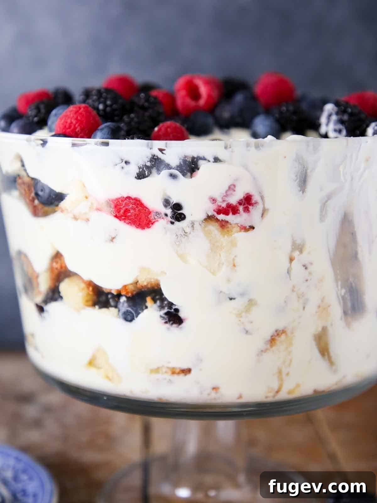 Summer Berry Dream 4 Side view of a vibrant berry trifle with clearly defined layers after some portions have been scooped out.