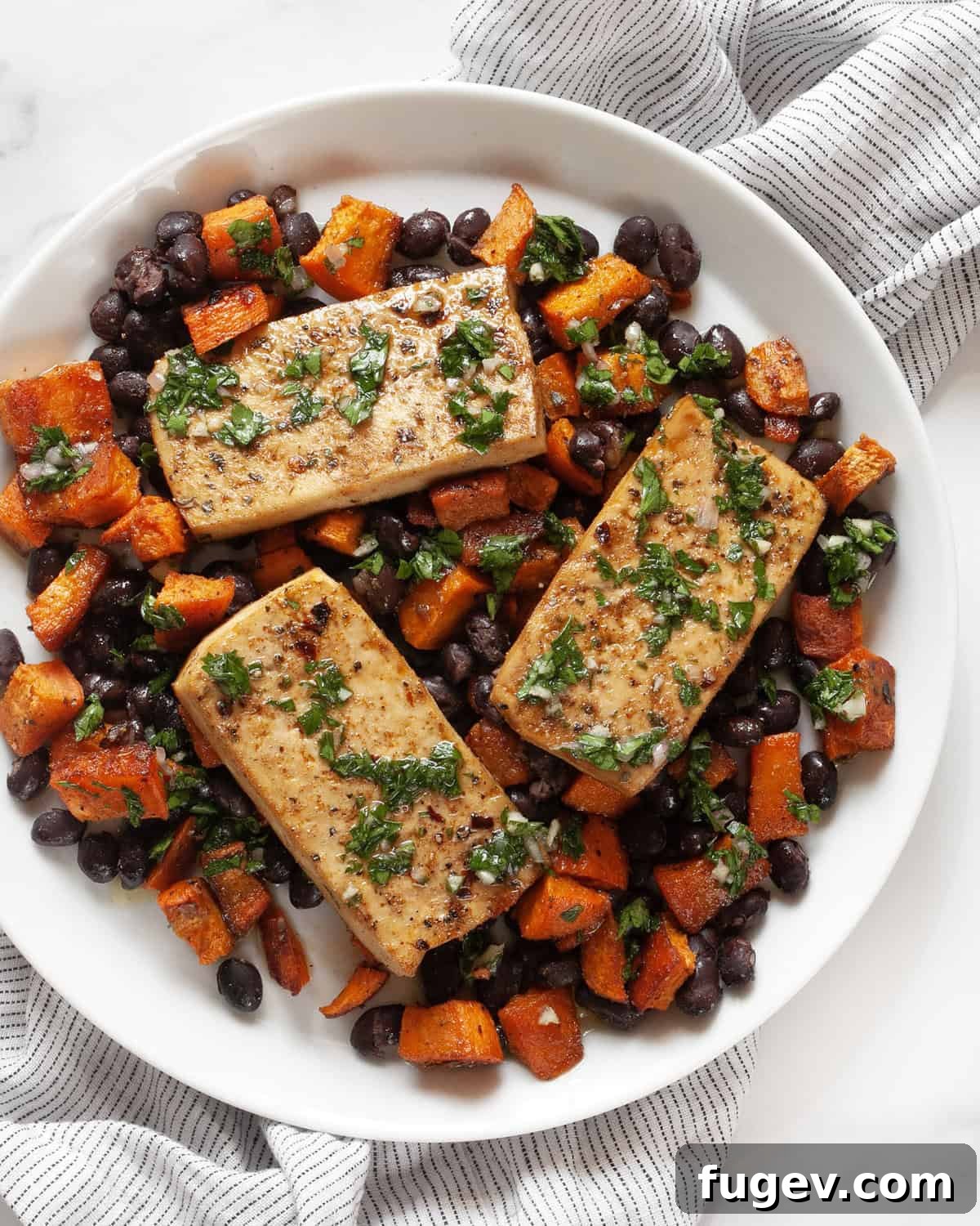 Hearty Sheet Pan Tofu Sweet Potato Black Bean Dinner 7 A close-up shot of the Sheet Pan Tofu, Sweet Potato, and Black Beans, plated and ready to be enjoyed.