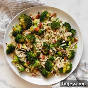 Orzo with roasted broccoli, almonds, lemon and garlic on a plate.