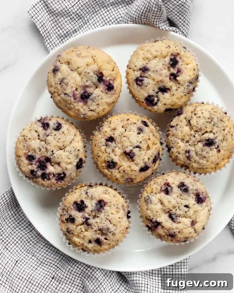 Plant-Based Blueberry Chia Burst Muffins 5 A cluster of freshly baked vegan blueberry chia muffins on a wire cooling rack