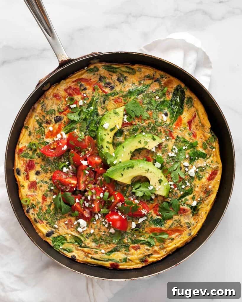 Hearty Roasted Pepper and Black Bean Frittata 2 Black Bean Roasted Pepper Frittata, topped with fresh cherry tomato pico de gallo and sliced avocado, ready to serve.