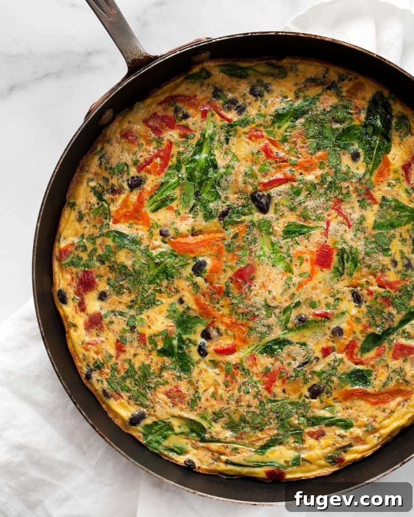 Hearty Roasted Pepper and Black Bean Frittata 4 A hearty Black Bean Roasted Pepper Frittata baking to golden perfection in an oven-safe skillet, with its edges gently browned and center puffed.