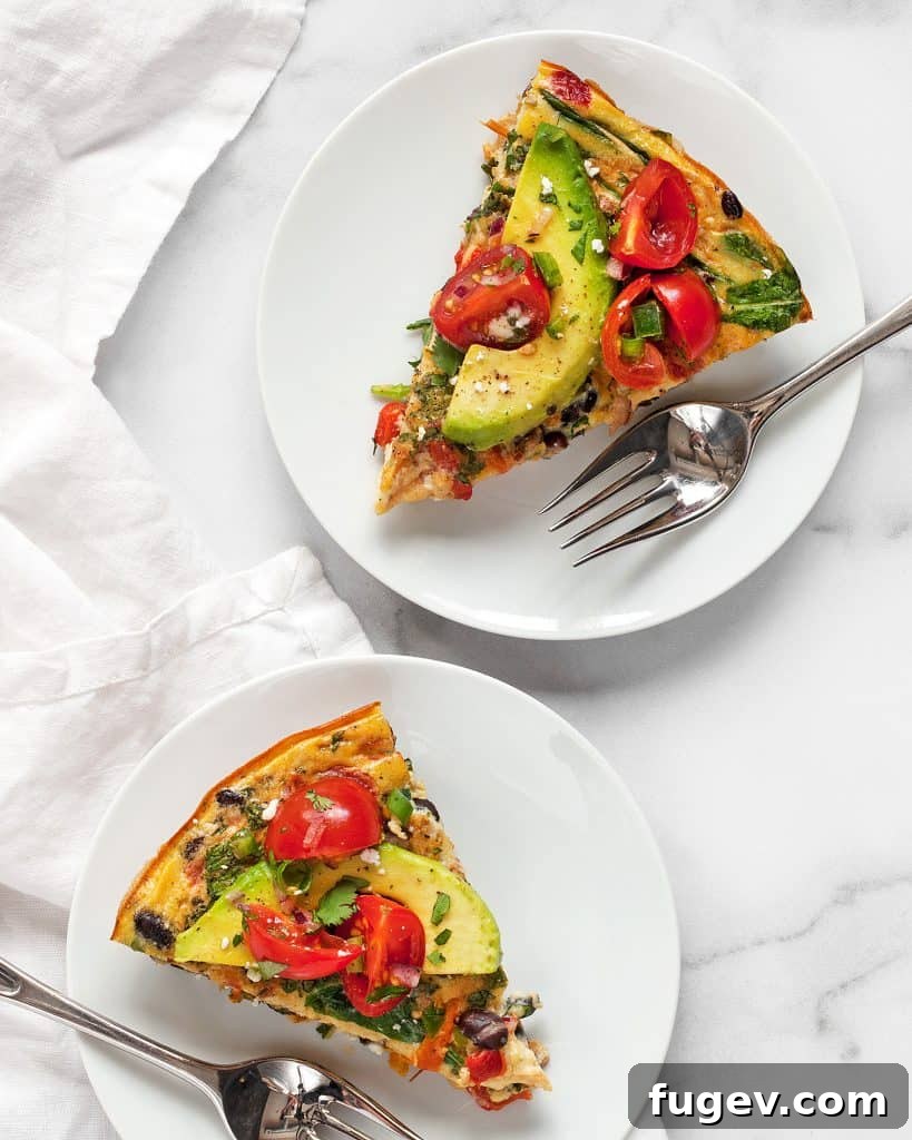 Hearty Roasted Pepper and Black Bean Frittata 7 Two perfectly cut slices of Black Bean Roasted Pepper Frittata adorned with creamy avocado slices, highlighting its meal-ready presentation.