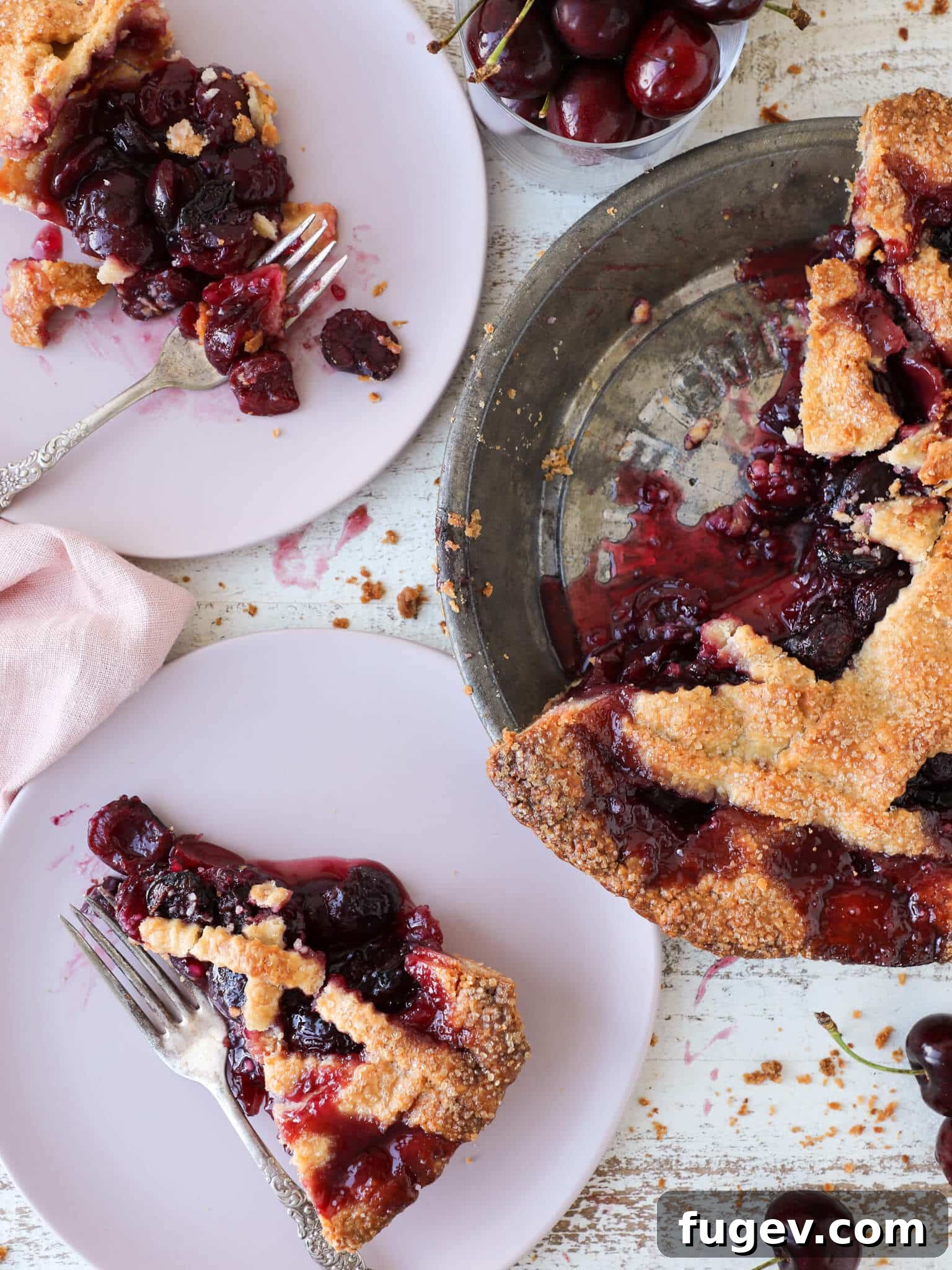 Crimson Delight 2 A beautifully sliced cherry pie in a vintage pie tin, showcasing a thick, juicy filling and golden-brown crust.