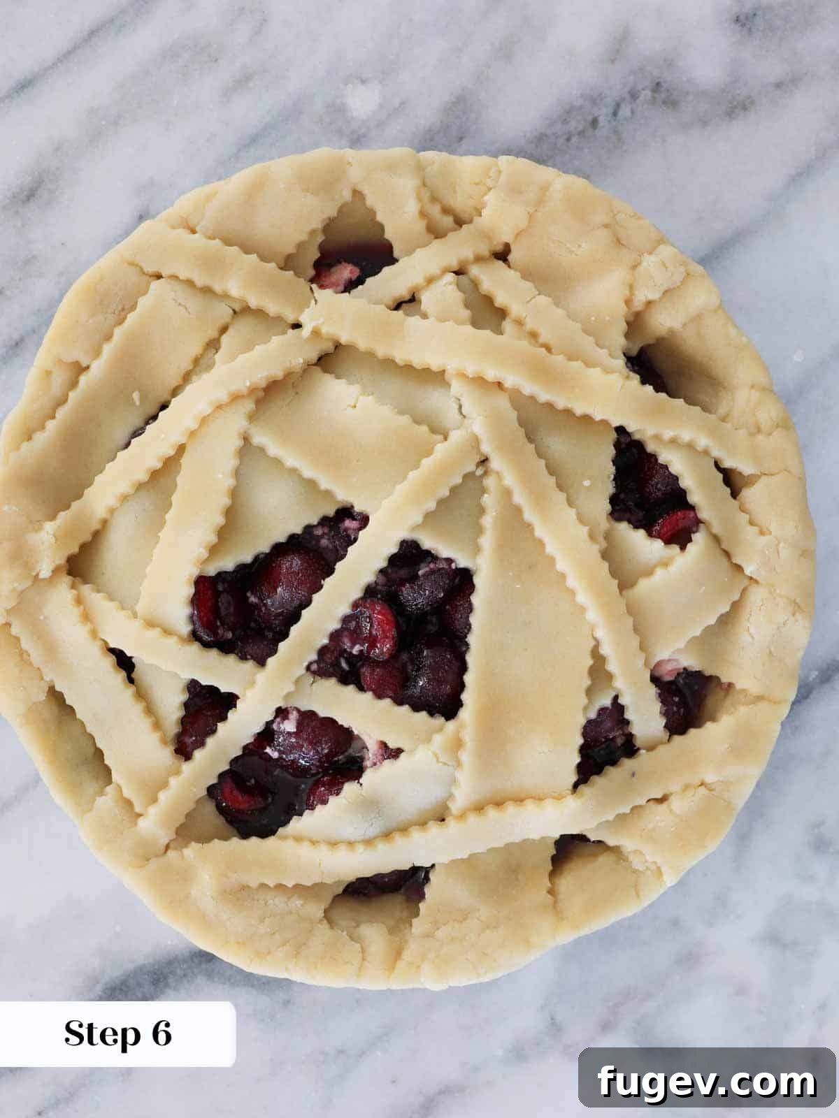 Crimson Delight 6 Unbaked cherry pie with trimmed and crimped edges, showcasing a neat, professional finish before baking.