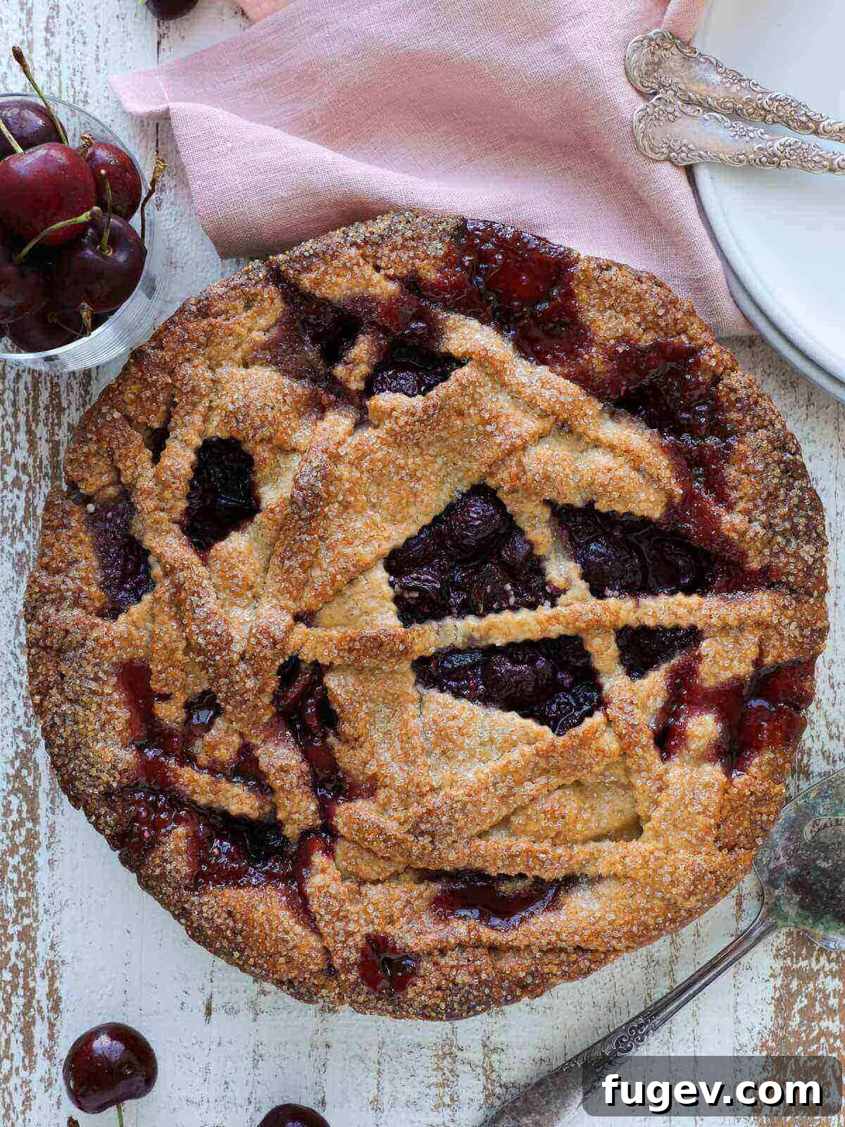 Crimson Delight 8 A perfectly baked cherry pie with an asymmetrical layered crust, fresh out of the oven.