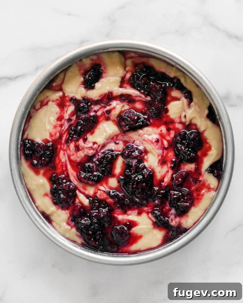 Zesty Lemon Blackberry Yogurt Bliss 6 Cake batter in a pan topped with blackberries