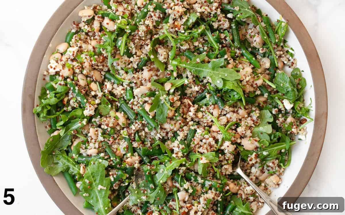 Green Bean Quinoa Bowl with White Beans and Toasted Almonds 6 A large bowl of Green Bean Quinoa with White Beans and Almonds, perfectly tossed with the lemon vinaigrette, showcasing its fresh and inviting appearance.