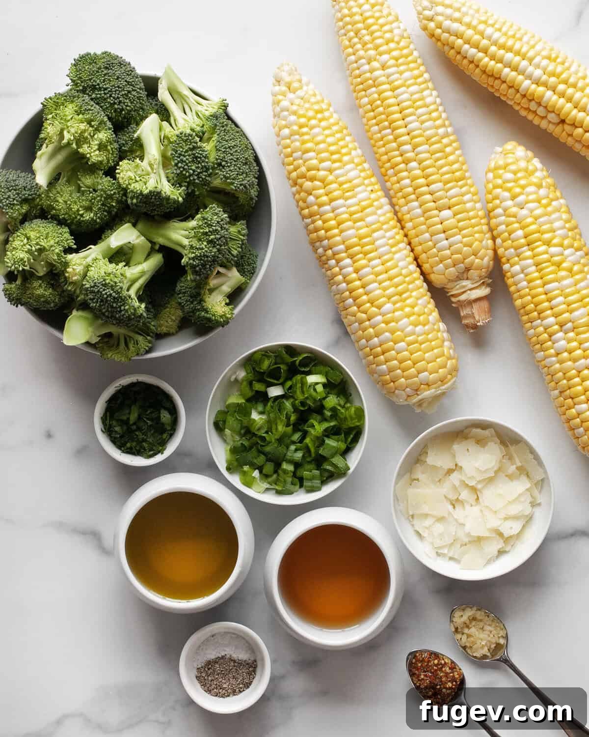 Charred Corn & Broccoli Medley 3 Fresh ingredients laid out for grilled corn broccoli salad, including corn, broccoli, scallions, cheese, parsley, garlic, mustard, white balsamic vinegar, and olive oil.