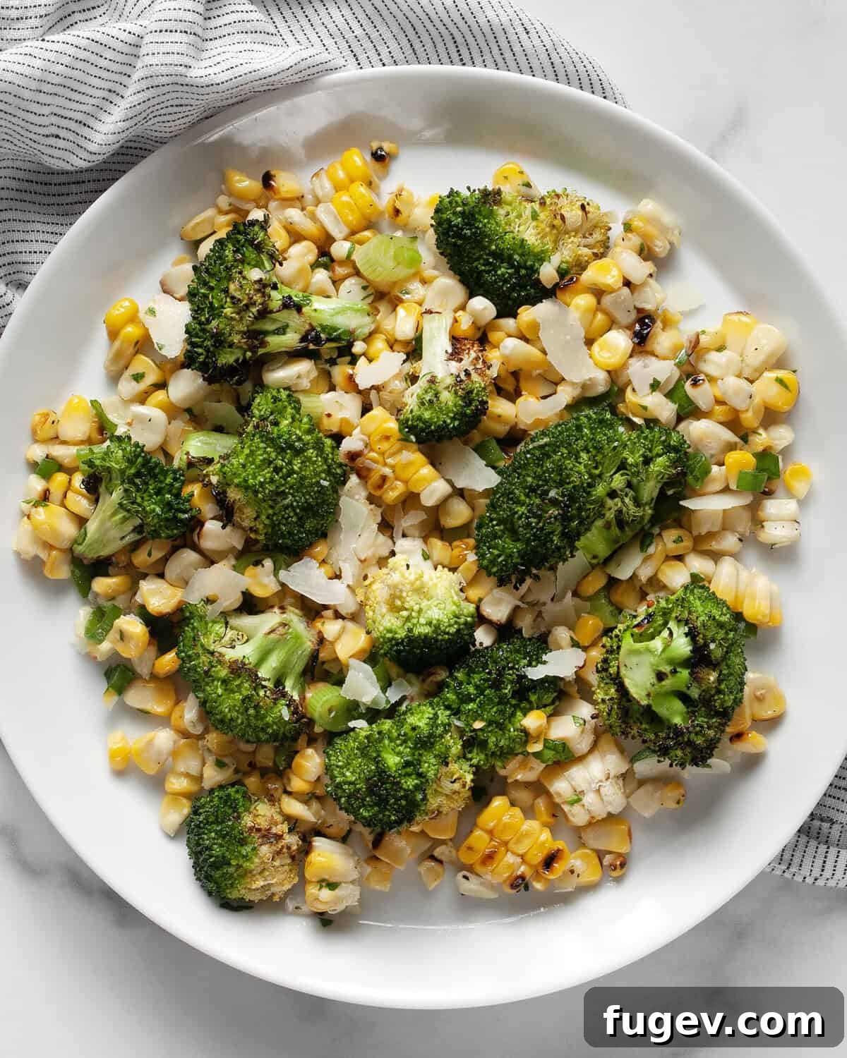 Charred Corn & Broccoli Medley 7 A single serving of grilled corn broccoli salad artfully arranged on a plate.