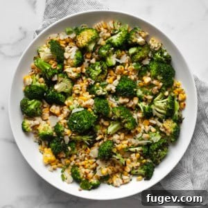 Charred Corn & Broccoli Medley 8 A vibrant bowl of grilled corn and broccoli salad, garnished with fresh herbs and cheese.