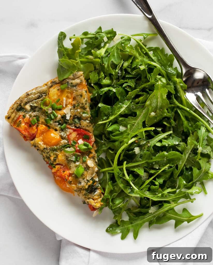 Pesto-Infused Tomato and Kale Frittata 7 Slice of frittata with mixed greens salad