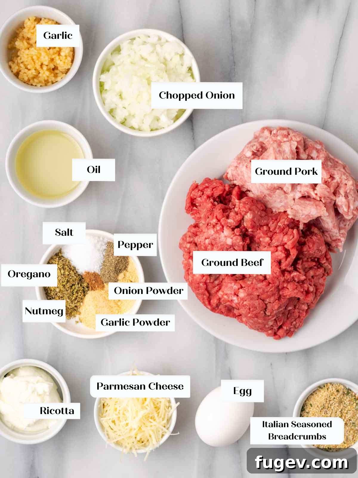 Cloud-Like Ricotta Meatballs 3 Fresh ingredients for homemade ricotta meatballs laid out on a marble counter, including meat, cheese, and herbs.