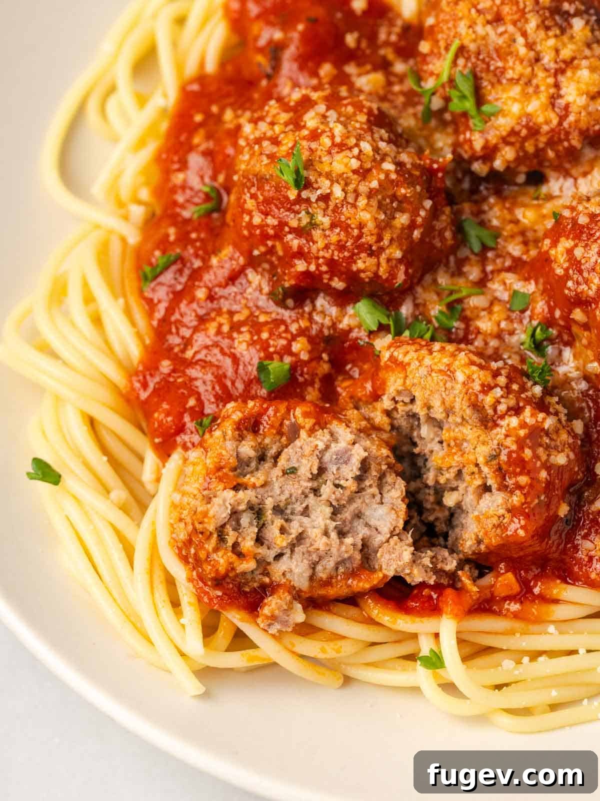 Cloud-Like Ricotta Meatballs 4 Close-up of the tender, moist interior texture of a cooked ricotta meatball, revealing its juiciness.