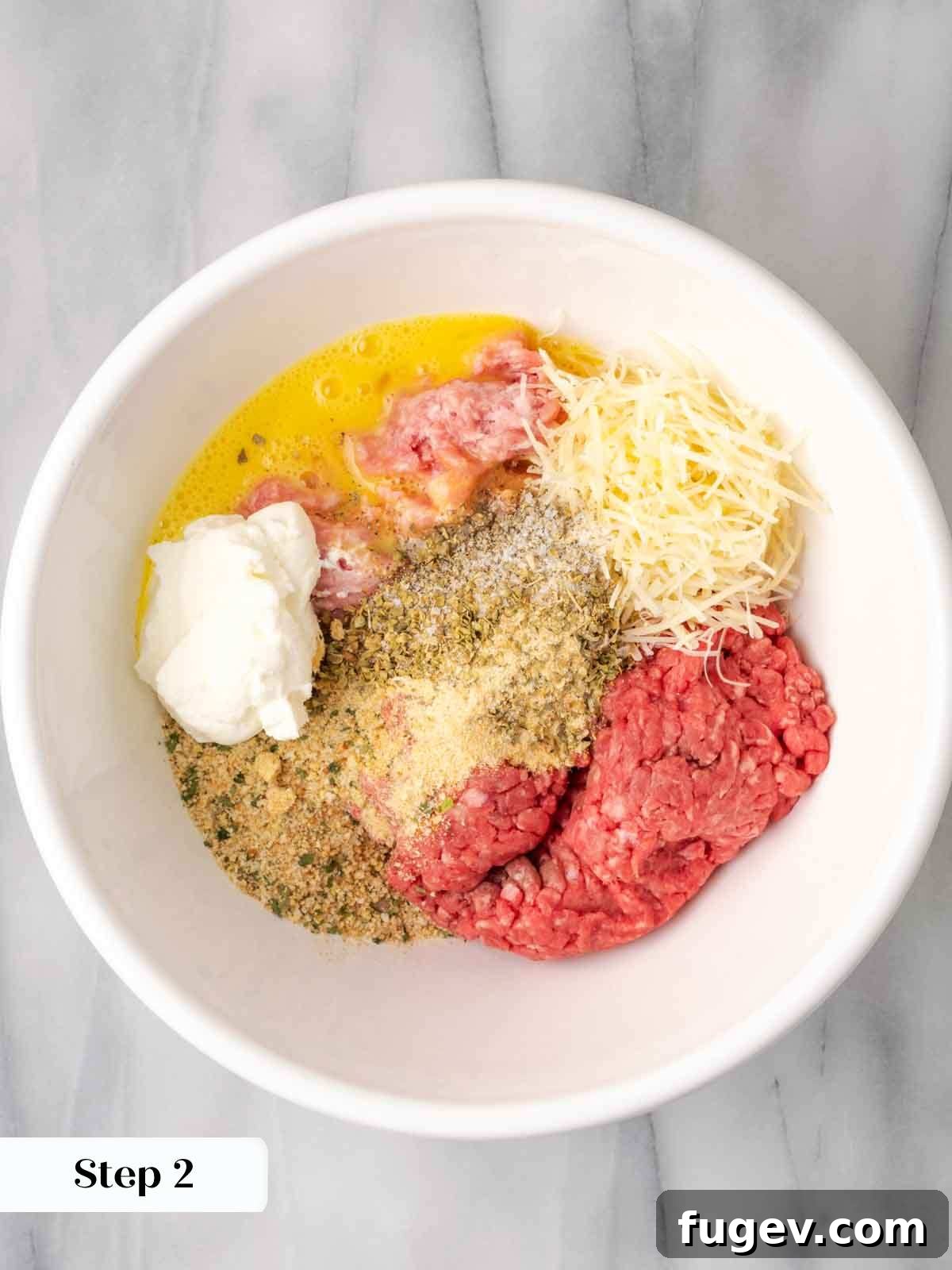 Cloud-Like Ricotta Meatballs 6 A bowl filled with raw ingredients for meatballs, including ricotta, meats, and spices, ready to be mixed.