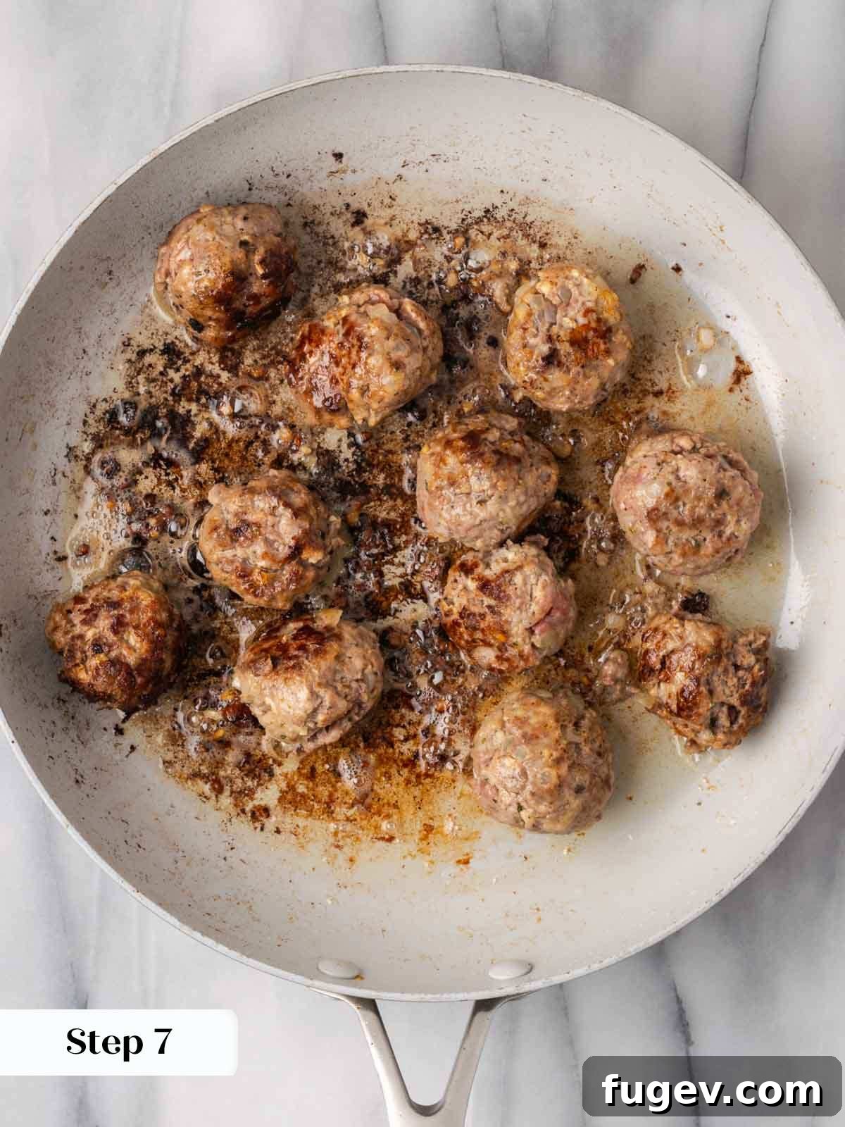Cloud-Like Ricotta Meatballs 9 Ricotta meatballs being browned evenly in a hot non-stick pan, developing a delicious crust.