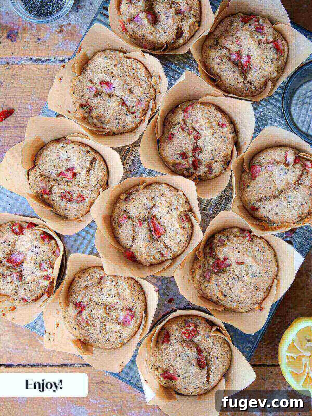 Homemade Strawberry Muffins 11 A tray of freshly baked strawberry muffins, golden-brown and puffed, cooling on a wire rack after being removed from the oven.