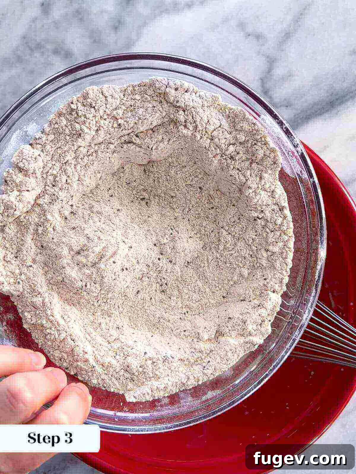 Homemade Strawberry Muffins 4 A bowl containing the dry ingredients for the strawberry muffins: whole wheat flour, all-purpose flour, baking powder, baking soda, salt, and chia seeds, mixed together.