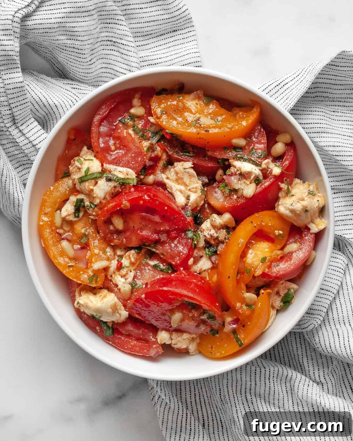 Vibrant Heirloom Tomato and Mozzarella Salad 2 A vibrant heirloom tomato and mozzarella salad in a rustic ceramic bowl, garnished with fresh basil.
