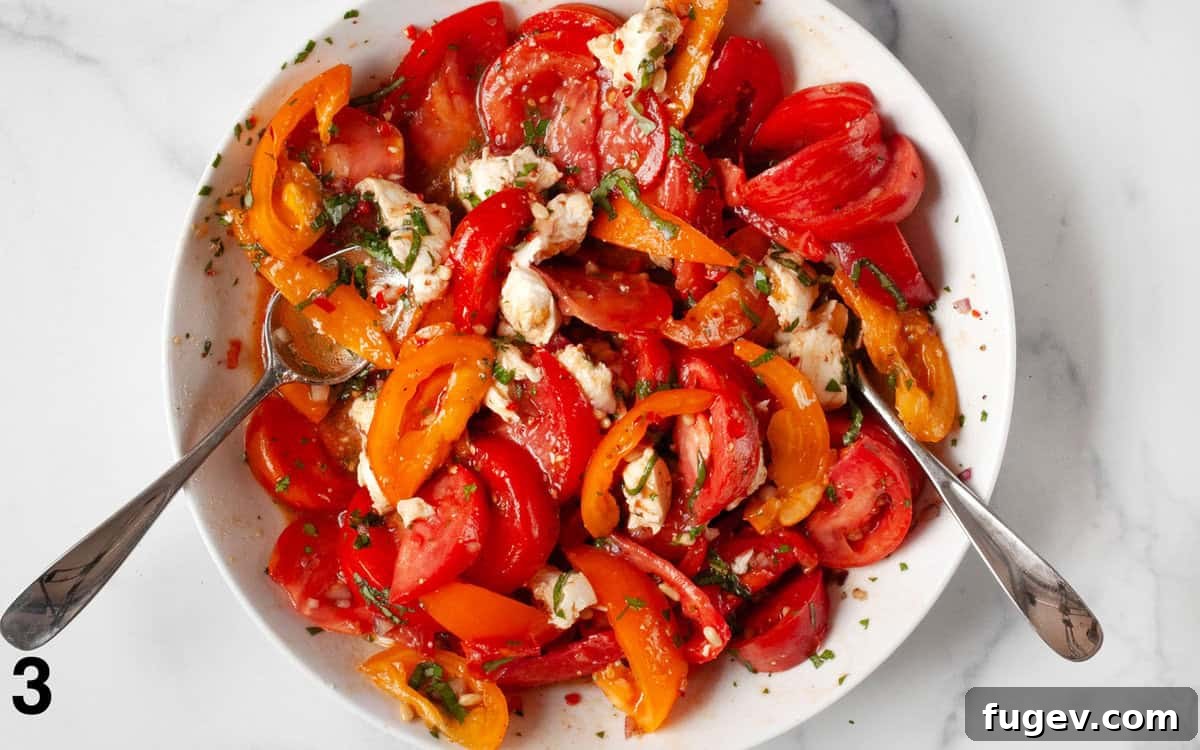 Vibrant Heirloom Tomato and Mozzarella Salad 5 The completed heirloom tomato and mozzarella salad, beautifully tossed and presented in a large bowl, ready to serve.