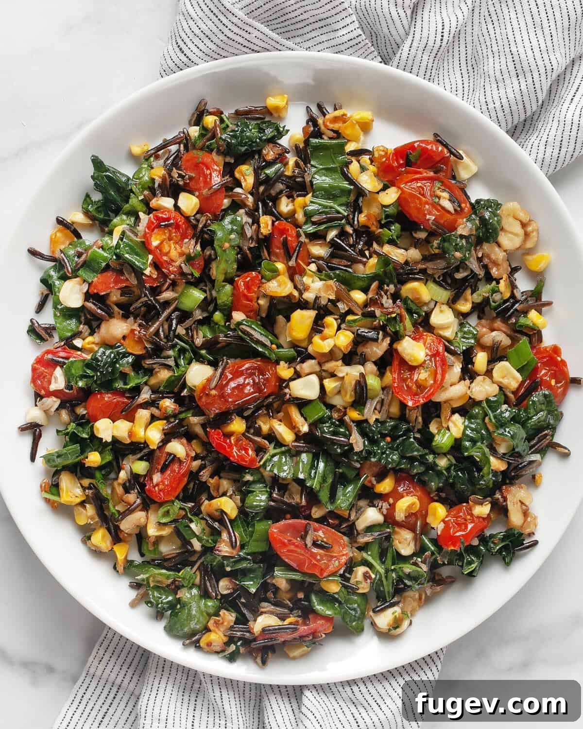 Vibrant Roasted Corn and Tomato Wild Rice Salad 7 Roasted corn and tomato wild rice salad beautifully arranged on a plate.