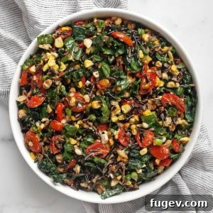 Roasted corn and tomato wild rice salad in a bowl, ready to serve.