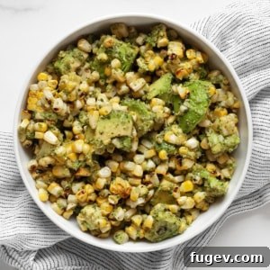 Grilled corn and avocados with cilantro pesto in a bowl.