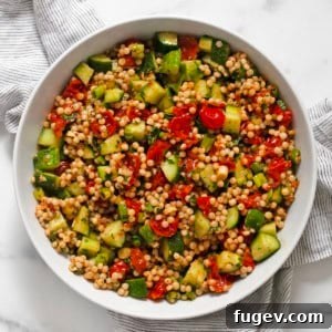 Harissa roasted tomato couscous in a bowl, ready to be served.