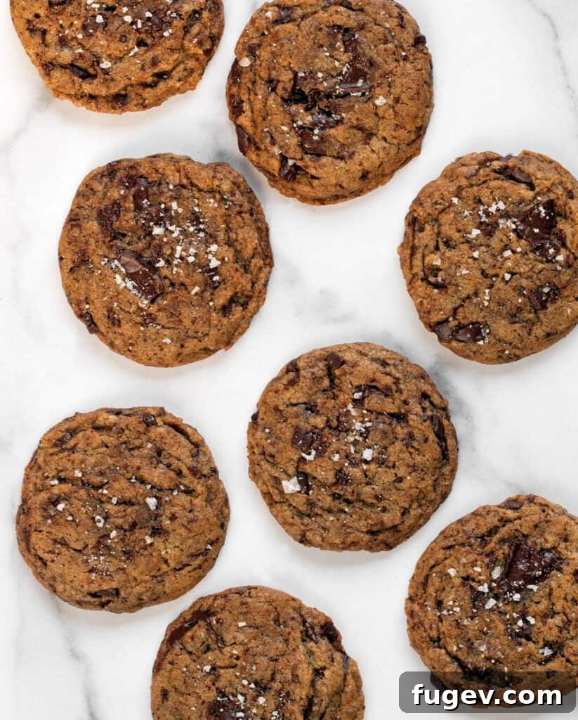 Cinnamon-Kissed Vegan Chocolate Chip Cookies 9 Freshly baked Vegan Cinnamon-Spiced Chocolate Chip Cookies on a cooling rack