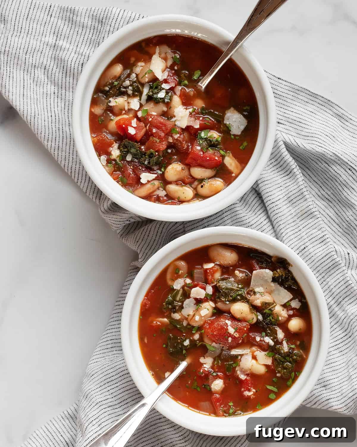 Rustic Rosemary White Bean Tomato Soup 2 Two bowls of rosemary white bean tomato soup, garnished with fresh herbs and a drizzle of olive oil.